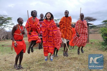 (141124) -- NAROK, Nov. 24, 2014 (Xinhua) -- A tourist (C) dances with young warriors of Maasai in Maasai Mara National Reserve in Narok, Kenya, Nov 21, 2014. The quantity of tourists in the reserve this year were less than that of the previous season. (Xinhua/Allan Muturi)
